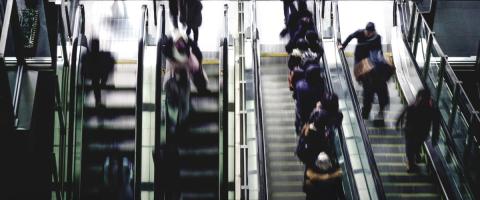 people running up and down escalators